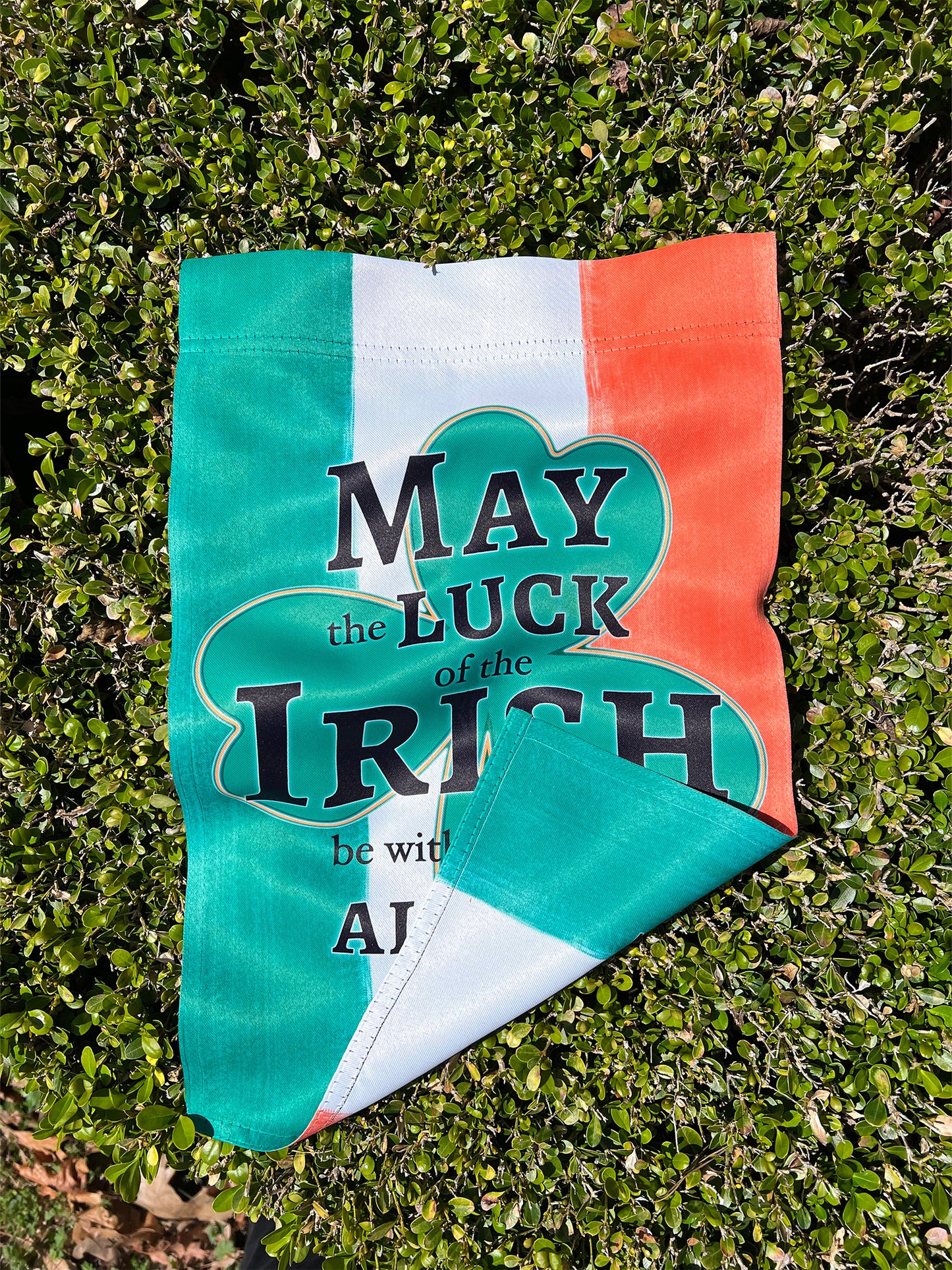 Close-up of the double sided print bold green shamrock on a 12x18-inch St. Patrick’s Day garden flag.