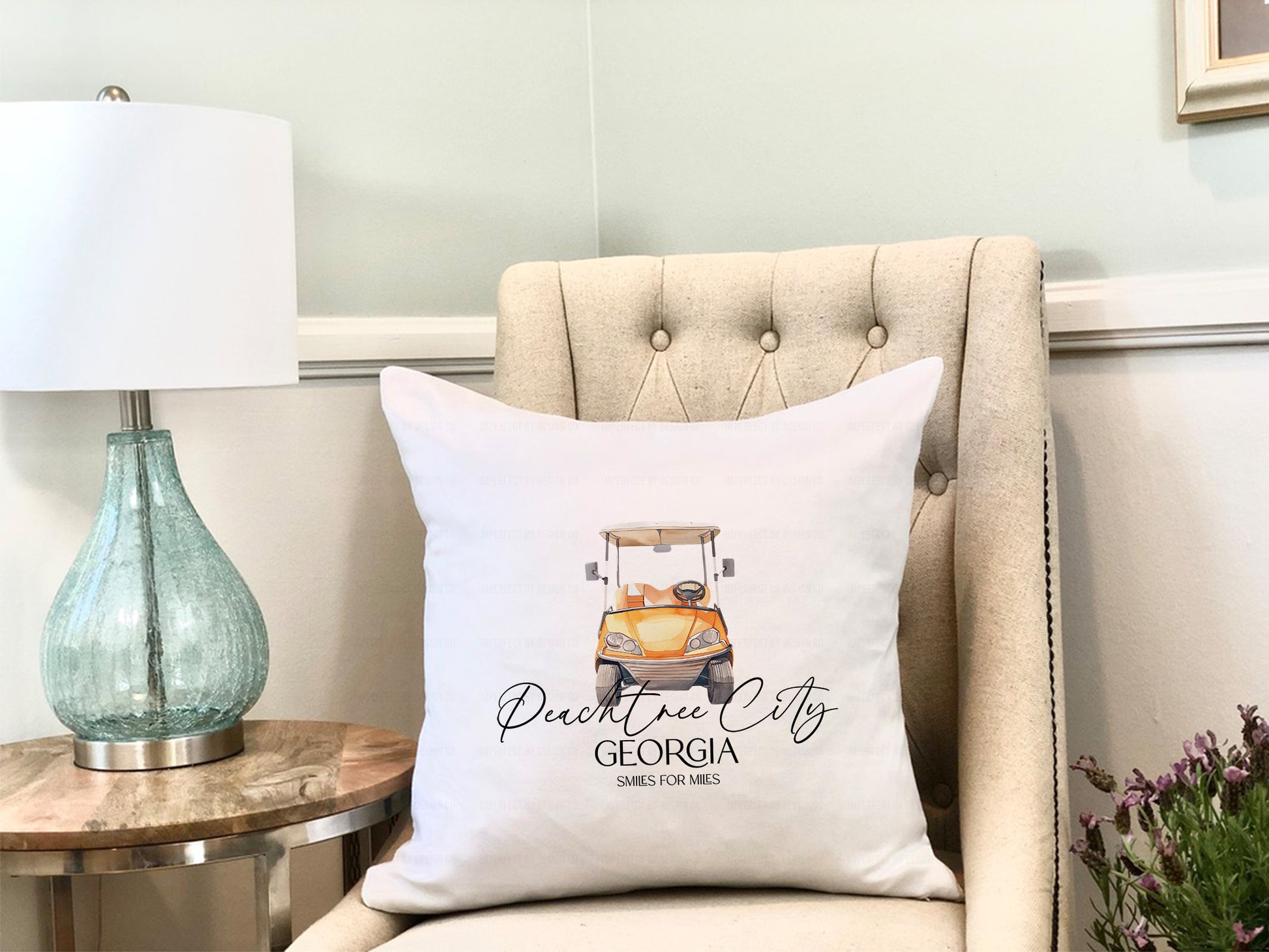 Decorative throw pillow cover featuring an orange golf cart and "Peachtree City" text.