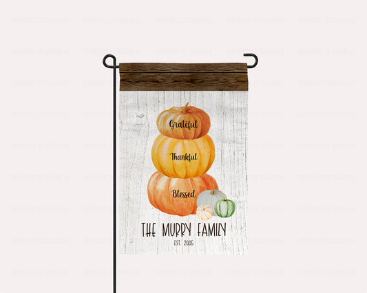 Personalized garden flag with a pumpkin stack reading 'Grateful, Thankful, Blessed' on a rustic wood background | imperfect by design co