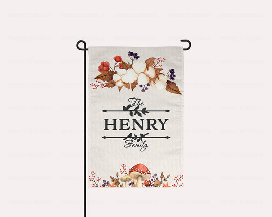 Personalized garden flag with family name and autumn foliage, including mushrooms and berries.
