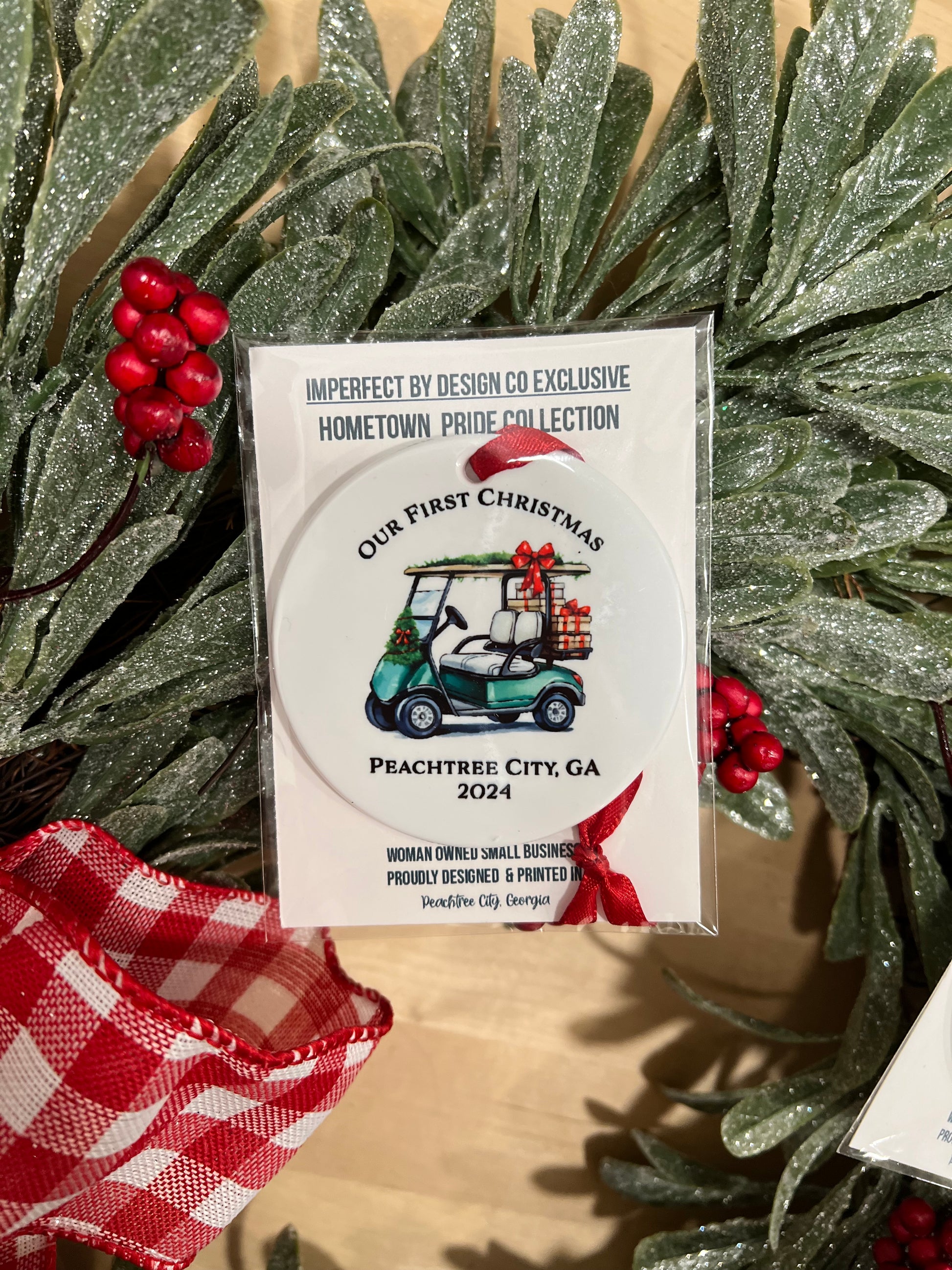 Packaged Glossy white double-sided golf cart Christmas ornament with red ribbon for hanging and personalized text option for city and year.
