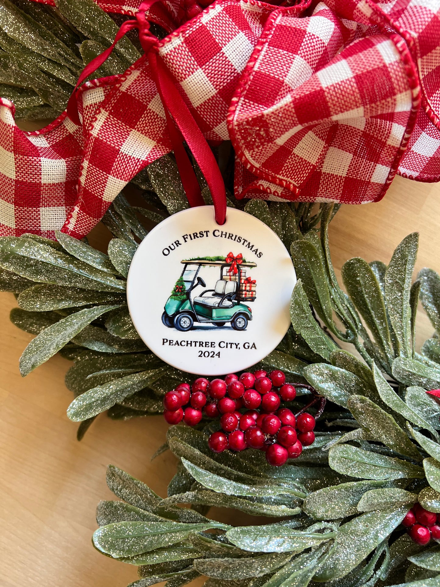 Christmas ornament featuring green golf cart loaded with gifts text "Our First Christmas" and "Peachtree City, GA 2024"