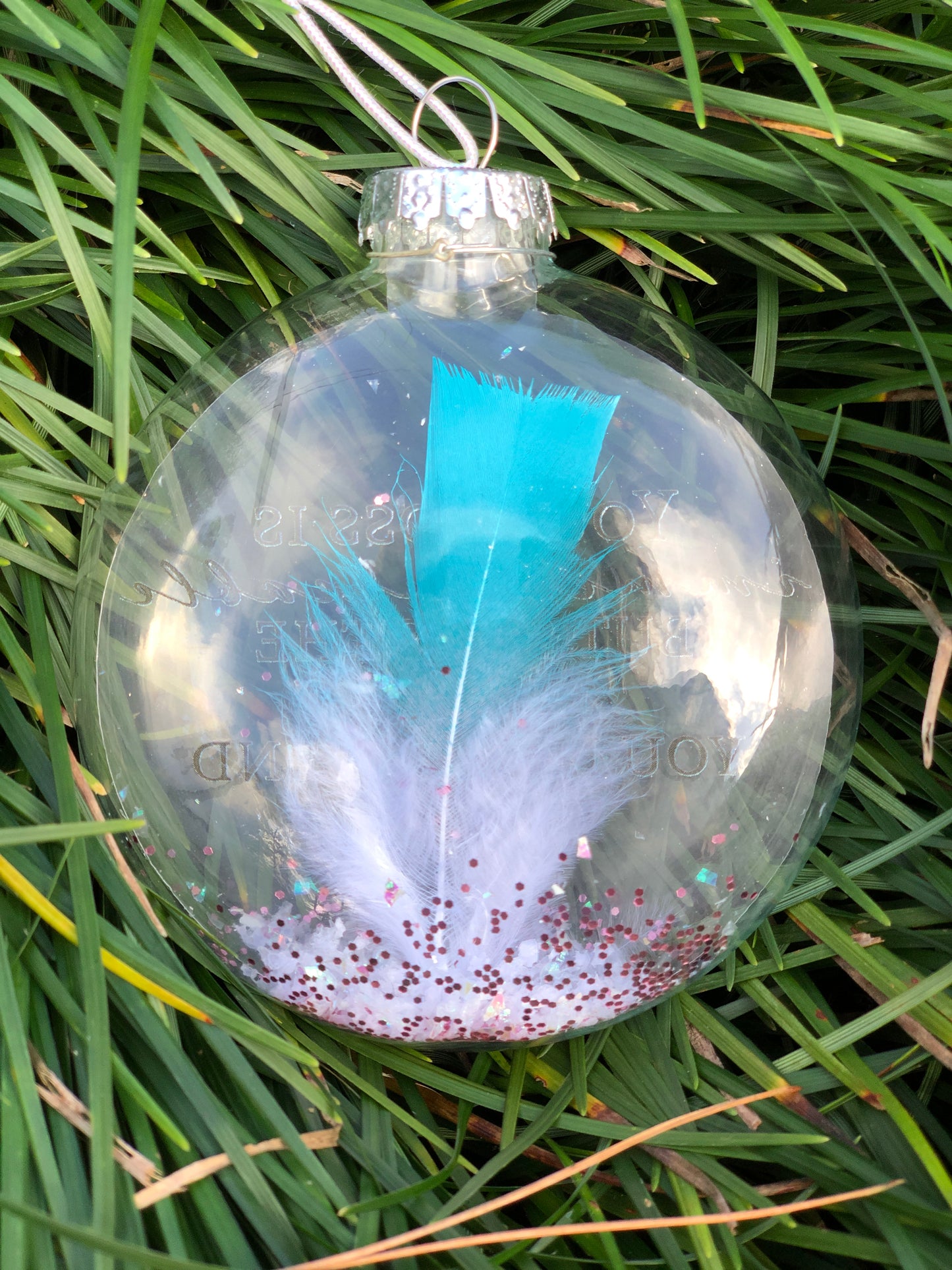 Back of Memorial ornament with rose gold text, angel charm, and faux snow for display.