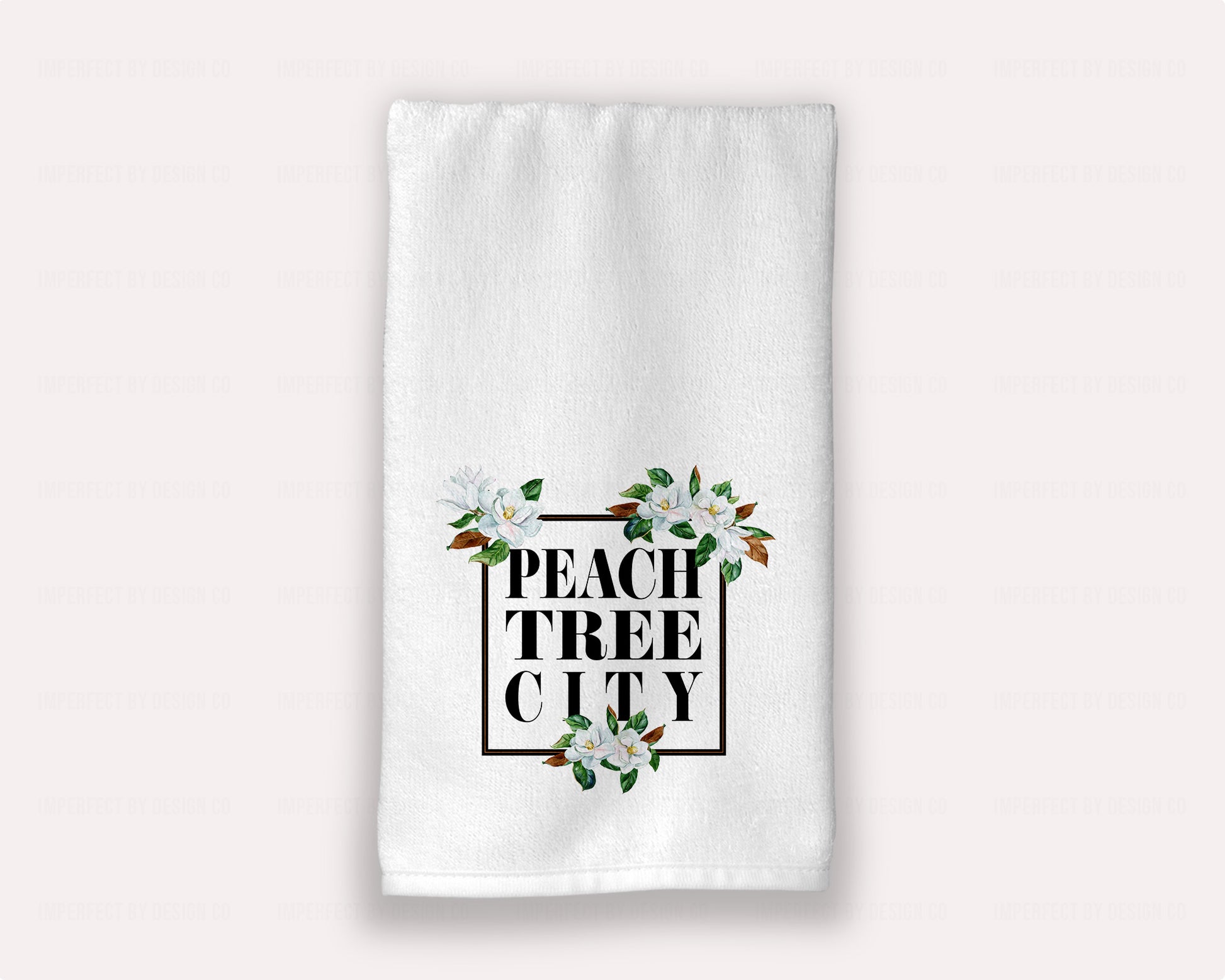 15x25 inches A luxurious white hand towel with Magnolia Blossoms and "Peachtree City" boldly printed in black, perfect for guest bath rooms | imperfect by design co
