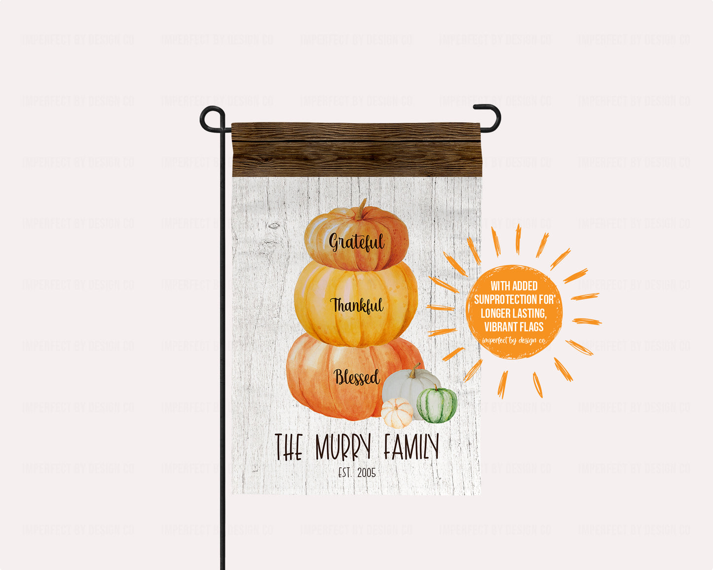 Fall-themed garden flag featuring a pumpkin stack and personalized text on a white and brown wood background