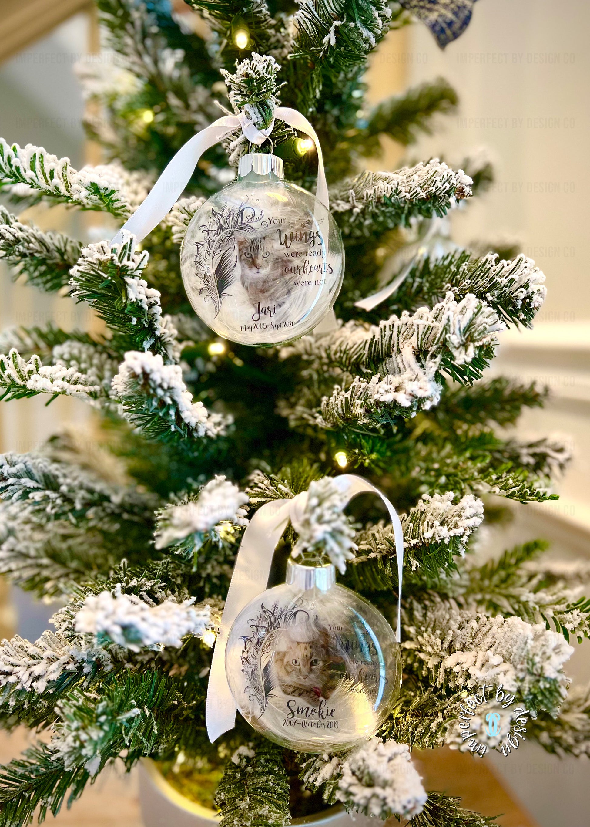 View of 2 different Customizable pet ornaments with white ribbon, pet's name, natural feather, and "Your wings were ready" text.