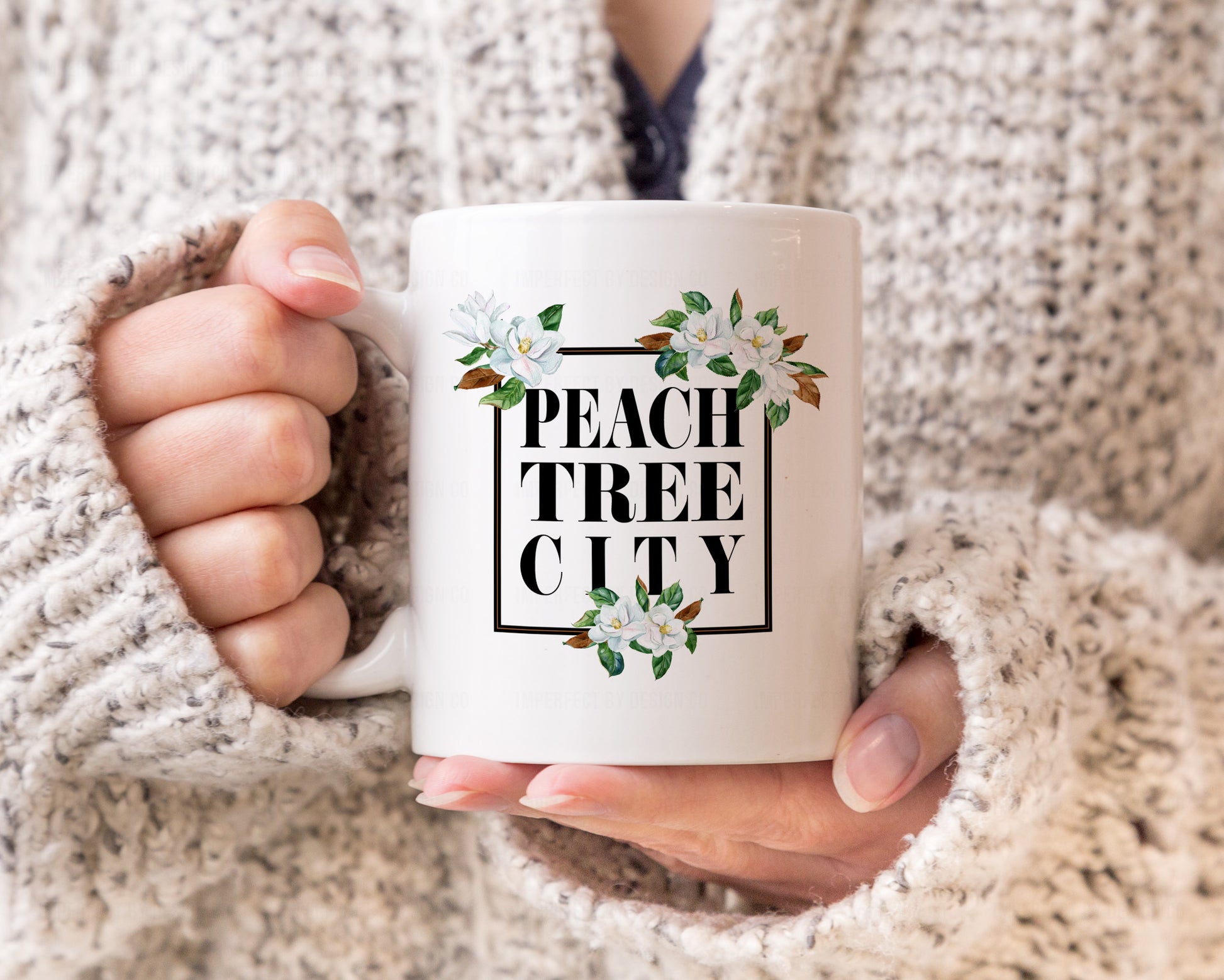 11oz Coffee Mug - Wake up to the beauty of Peachtree City with our magnolia coffee mug. Its stunning design featuring the city's name and date established on a crisp white mug will make you feel proud to be a resident or a fan. The comfortable handle makes it perfect for sipping your morning coffee, tea or hot cocoa. | imperfect by design co