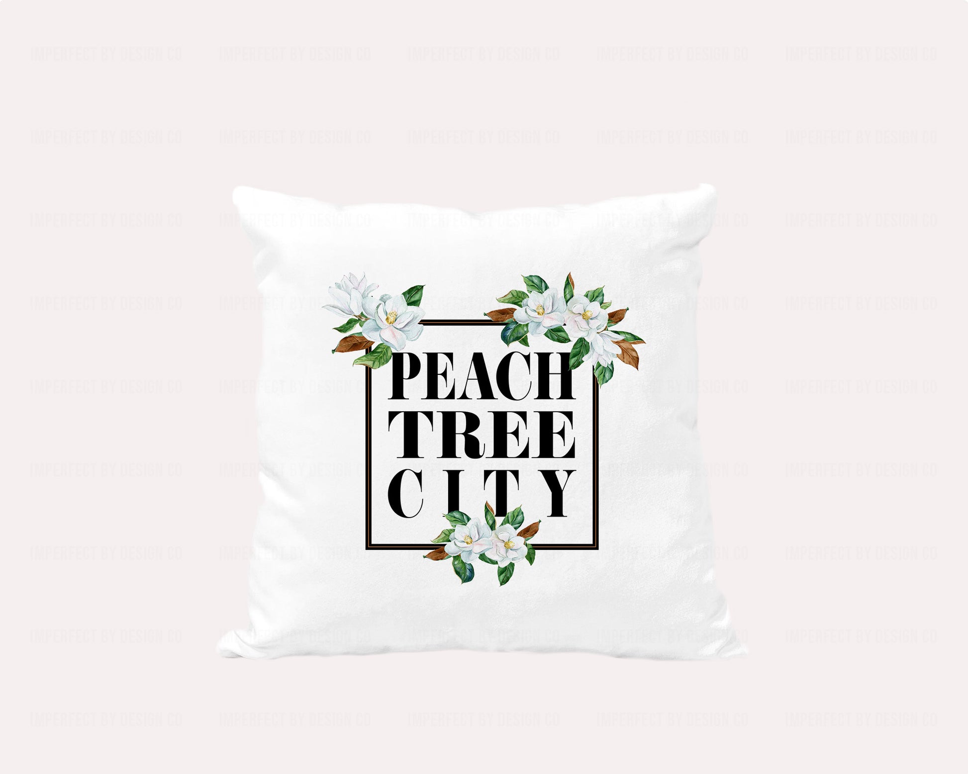 18x18 inches A white velvet pillow cover featuring a stunning graphic with a black frame adorned with magnolia blooms and the words "Peachtree City" inside the frame | imperfect by design co