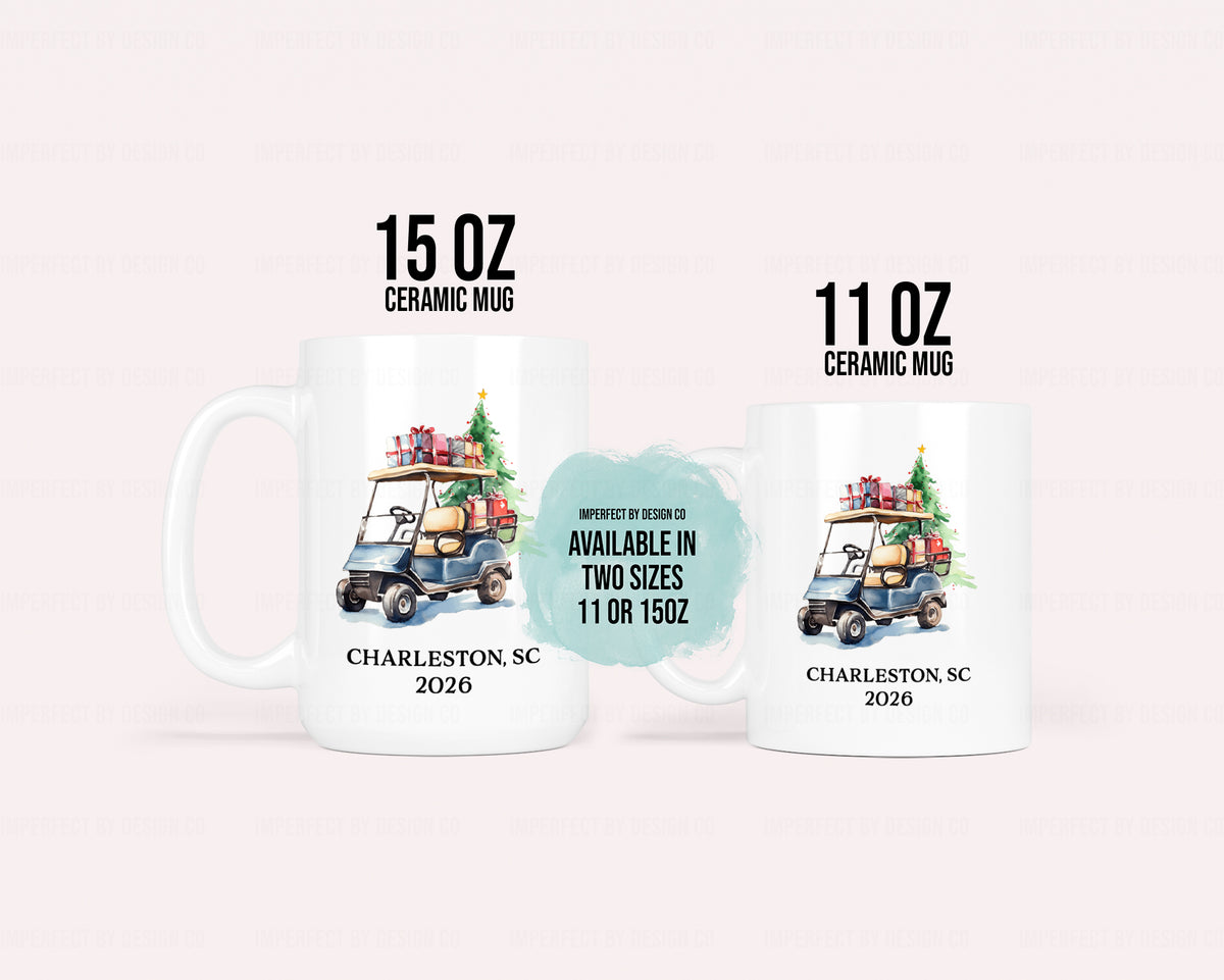 Two white ceramic mugs shown on a pale pink background, labeled 15 OZ and 11 OZ. Each mug features a golf cart carrying a Christmas tree and presents, with the text 'CHARLESTON, SC 2026' printed below.