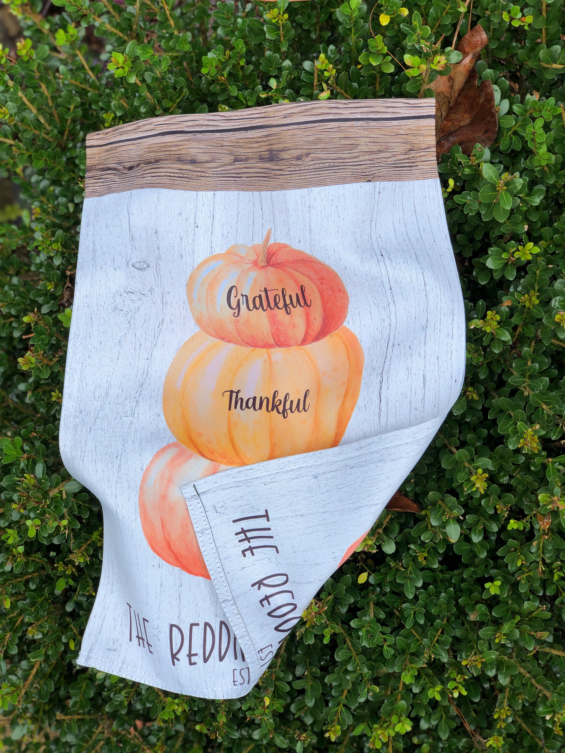 Rustic fall garden flag with a stack of pumpkins and custom last name, perfect for Thanksgiving décor