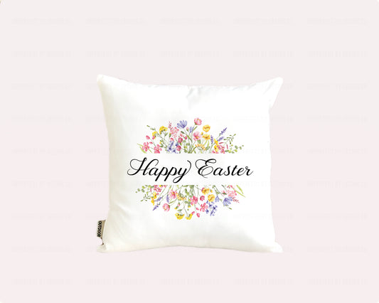 White decorative indoor outdoor pillow advertising pillow cover with 'Happy Easter' text and floral designs on a pale pink background. imperfect by design co 