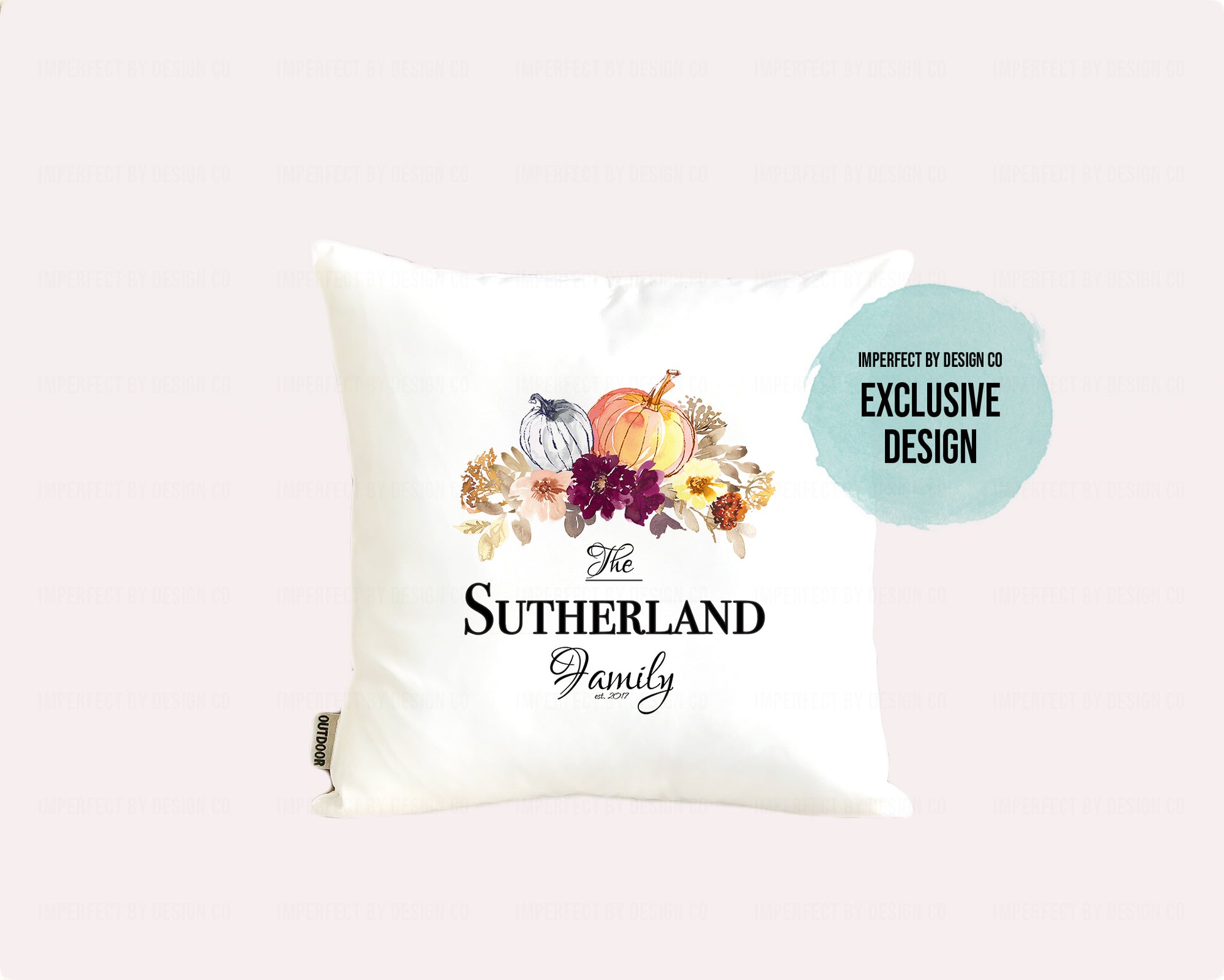 Decorative pillow (cover)  with 'The Sutherland Family' text, pumpkins and floral design on a pale pink background
Text blurb reads imperfect by design co exclusive design
