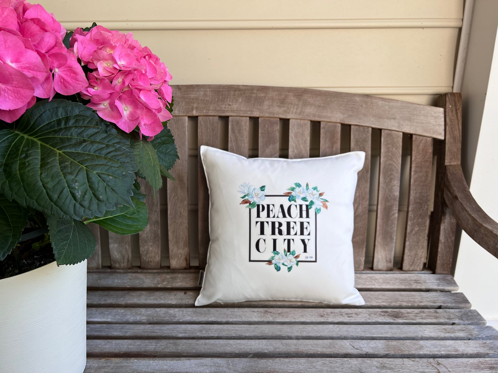 16x16 Magnolia Graphic Peachtree City Pillow on Bench with Hydrangea  | imperfect by design co