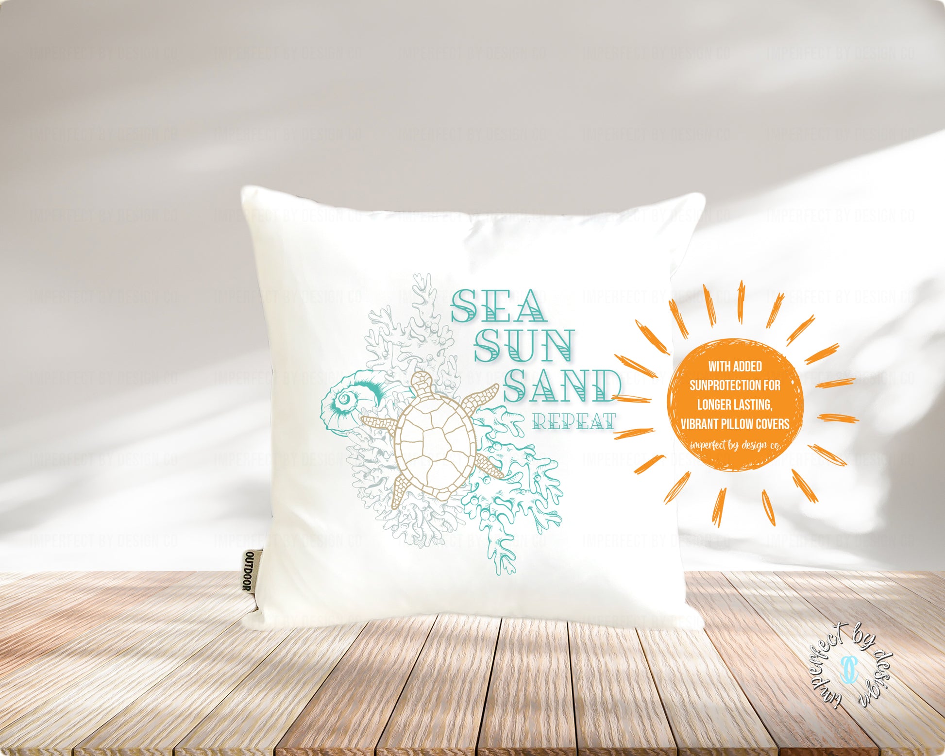 Decorative pillow with turtle design, 'Sea Sun Sand Repeat' text, and sun graphic on a pale pink background with wood planks  with added text graphic 'sun protection for longer lasting vibrant flags' | imperfect by design co