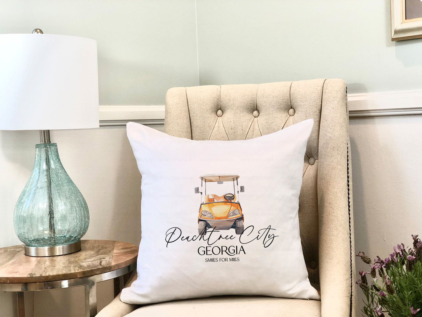 Decorative throw pillow cover featuring an orange golf cart and "Peachtree City" text.
