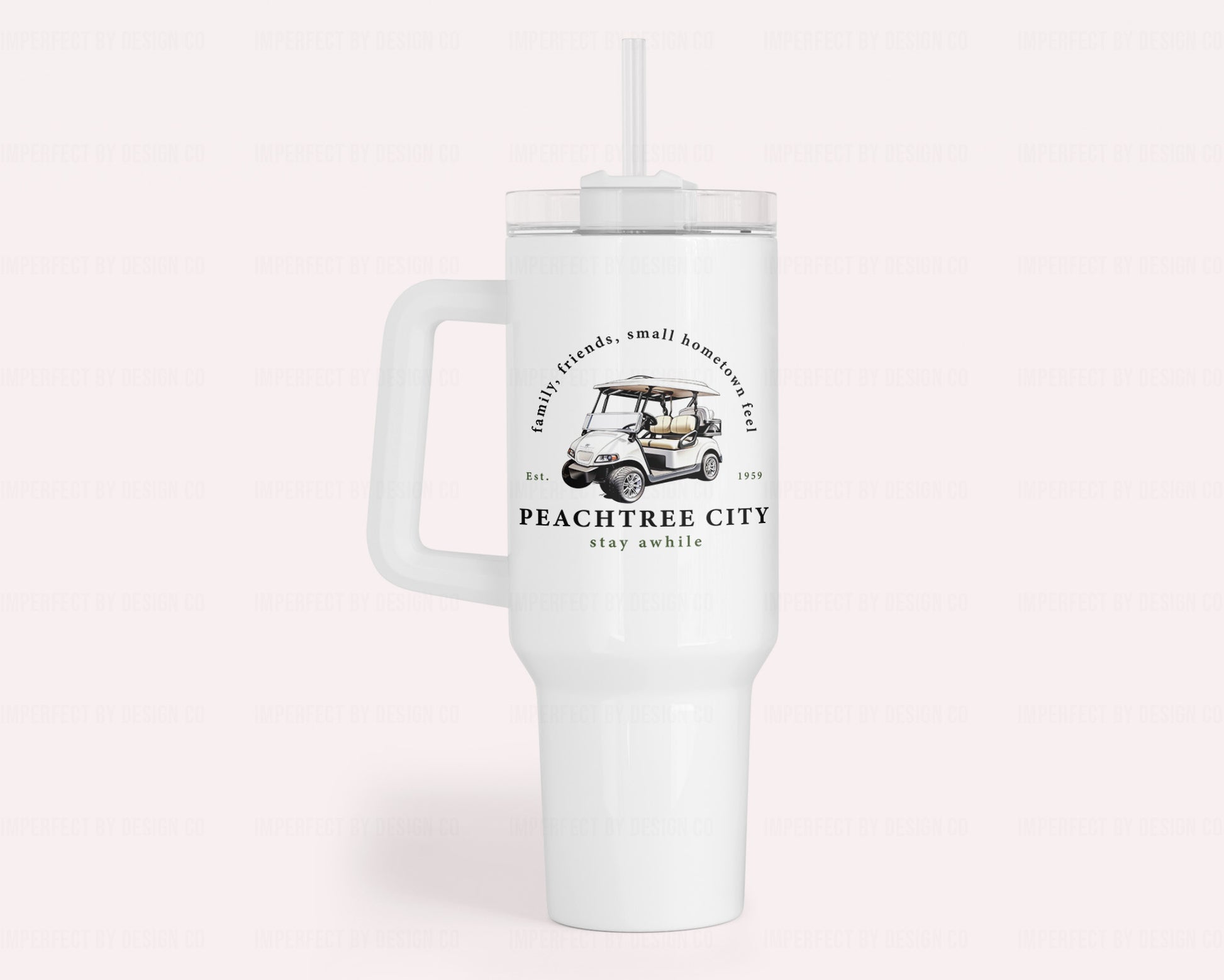 A white 40oz insulated stainless steel tumbler featuring a white golf cart and text on the front and back. Text reads 'family, friends, small hometown feel' 'Est. 1959' Peachtree City stay awhile'  | imperfect by design co exclusive