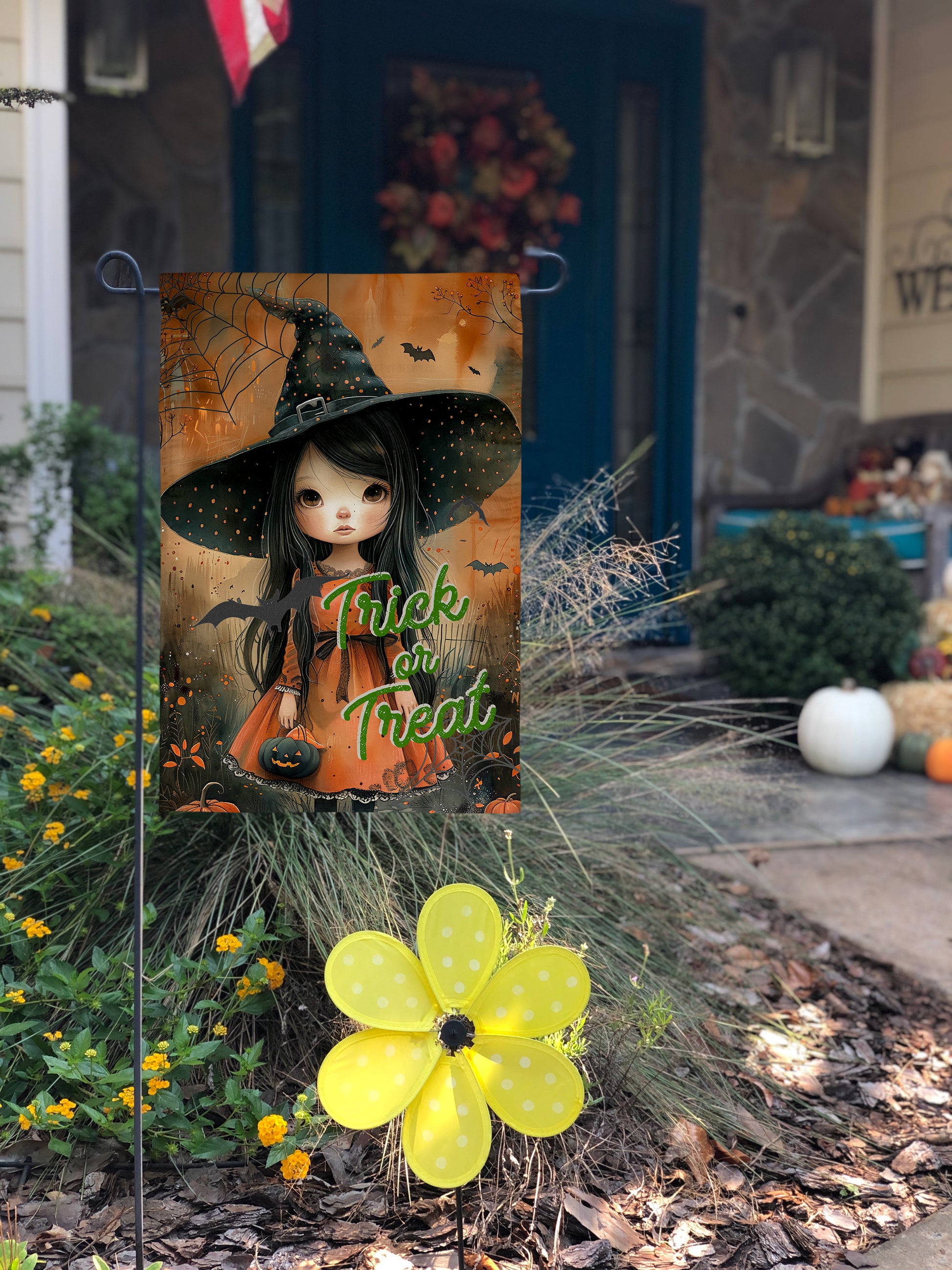 Charming Halloween garden flag with vibrant autumn colors and a sweet little witch design. Trick or Treat text.
