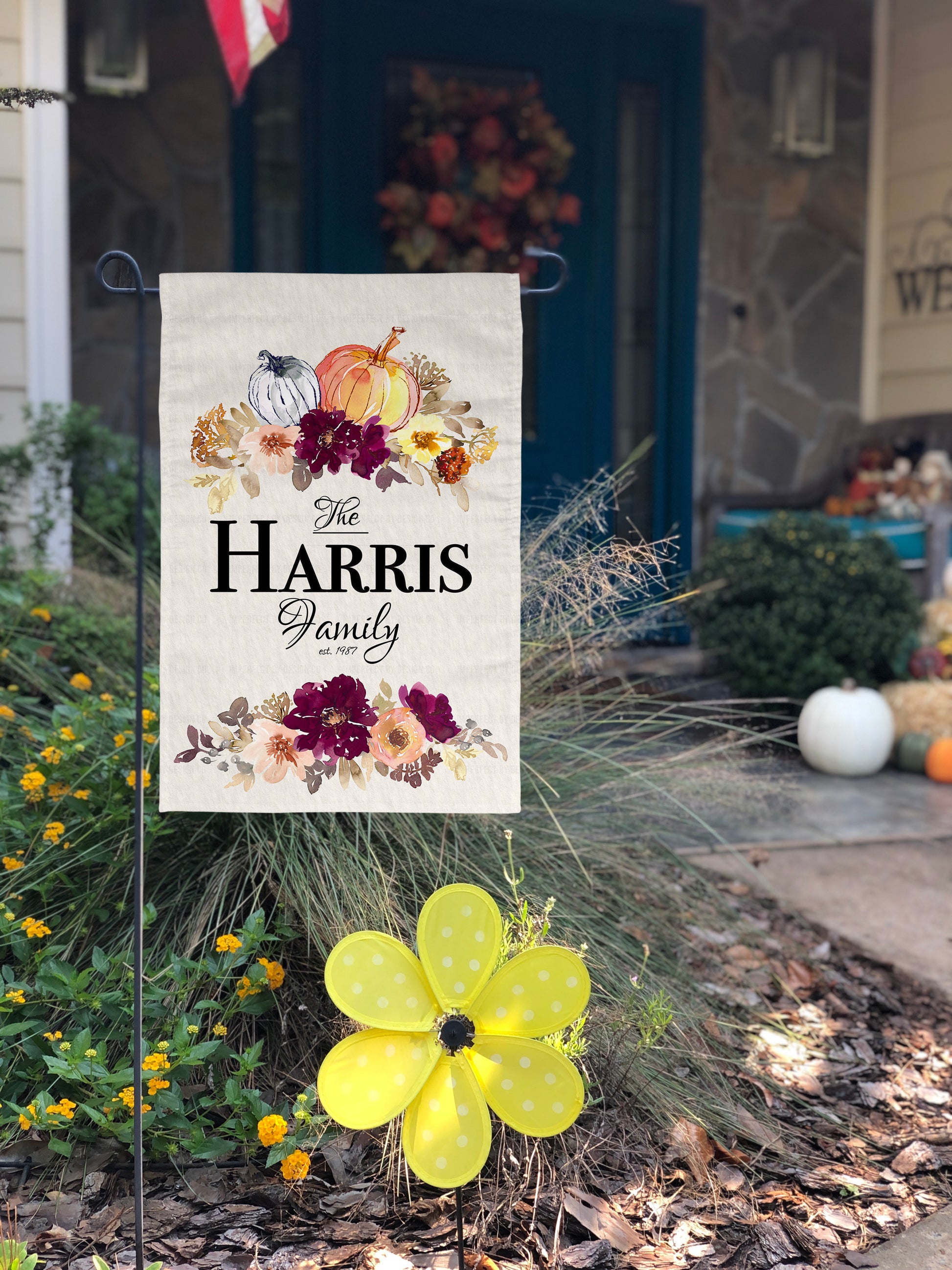 Pumpkin and floral themed fall garden flag, customizable with your family name and established year.