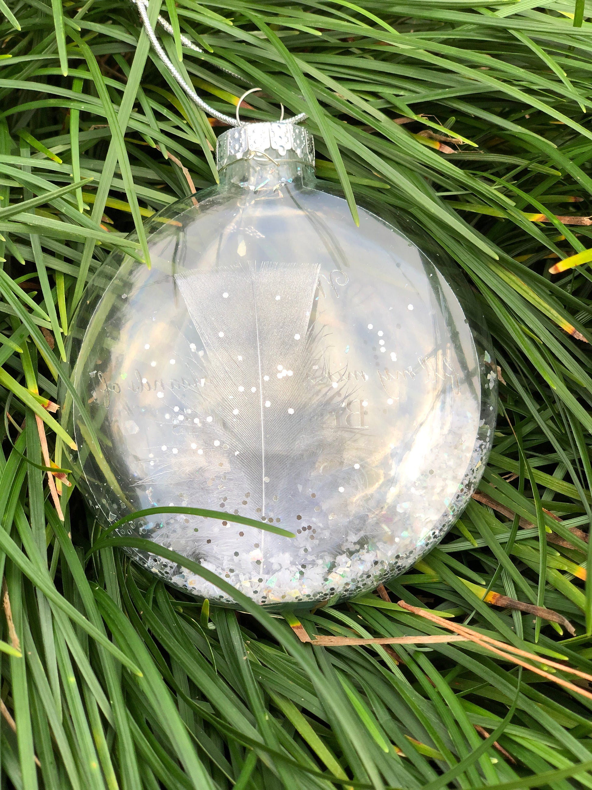 Personalized glass ornament with pewter text, faux snow, and angel charm.