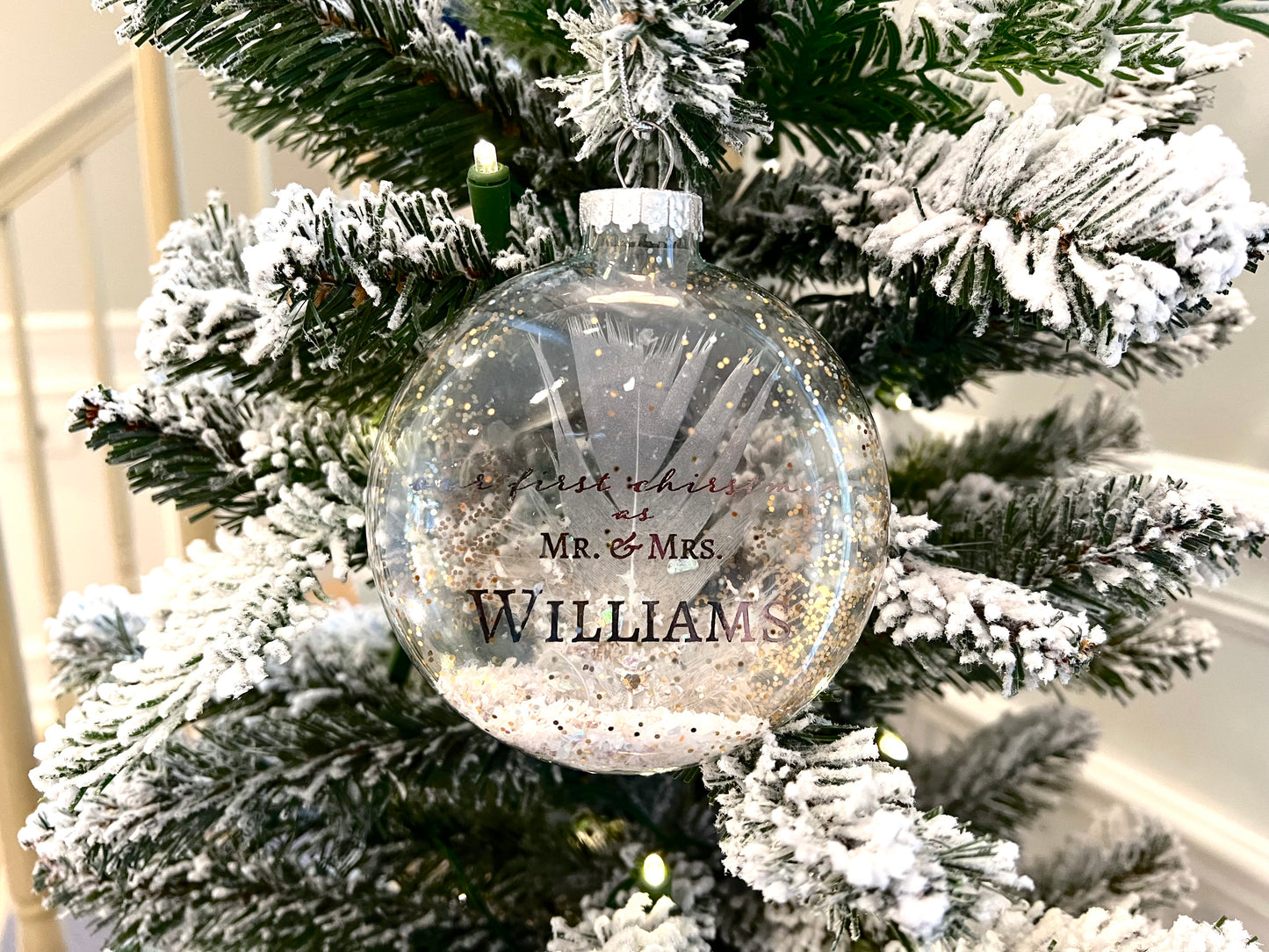 Close-up of Floating Pewter Foil Text in Ornament – Close-up view of the elegant pewter foil text, "Our First Christmas as Mr. & Mrs. [Last Name]" with the year, floating inside the transparent glass bulb.