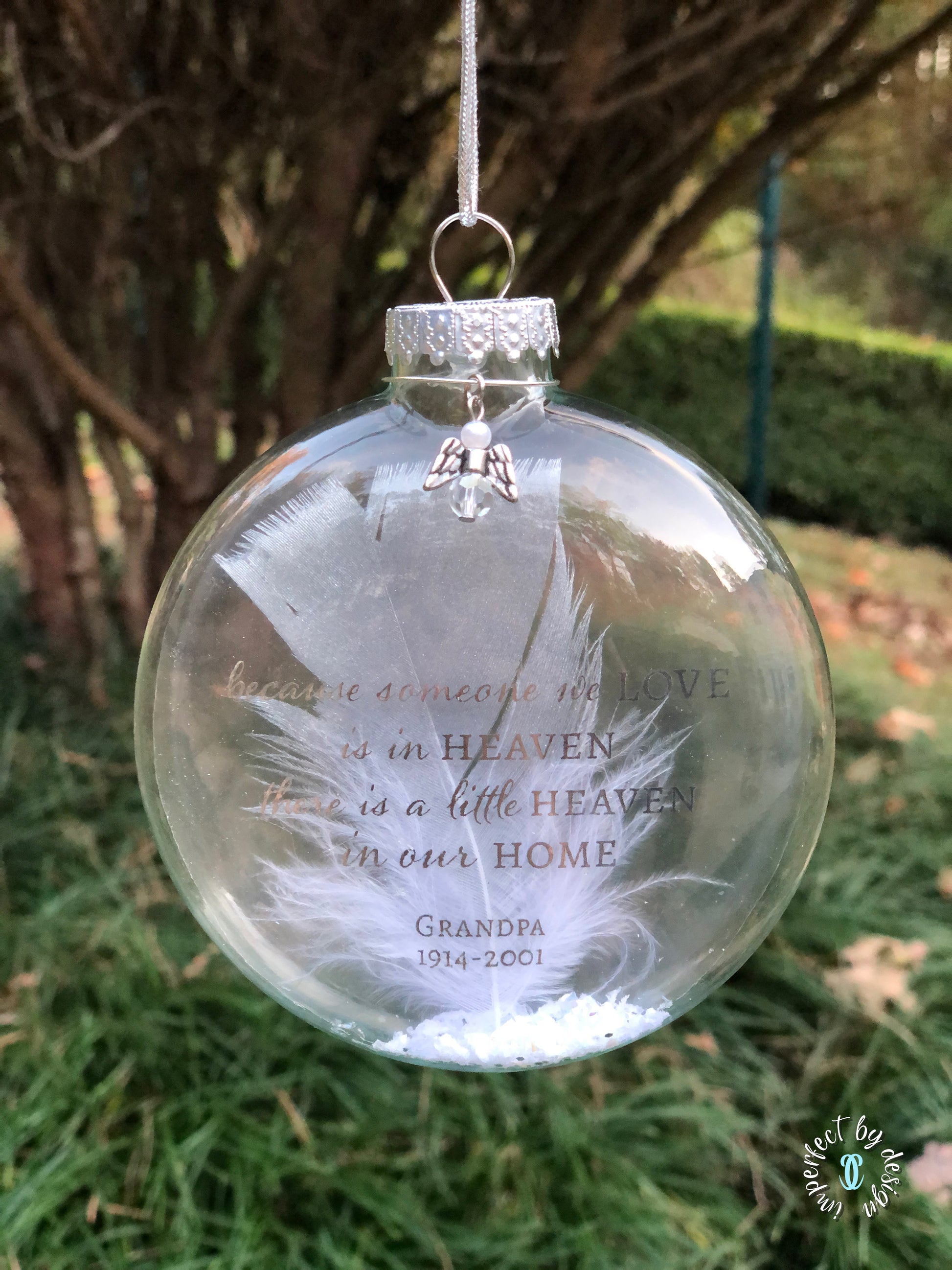 Close-up of Silver Metallic Text on Memorial Ornament – Close-up view showing the elegant silver metallic text "Because someone we love is in heaven there is a little heaven in our home," with a personalized name and years of life floating inside the glass.