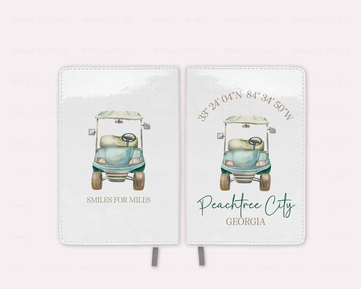 Front and Back image of golf cart illustrations and text on a  white journal/notebook. Placed on a pale pink background