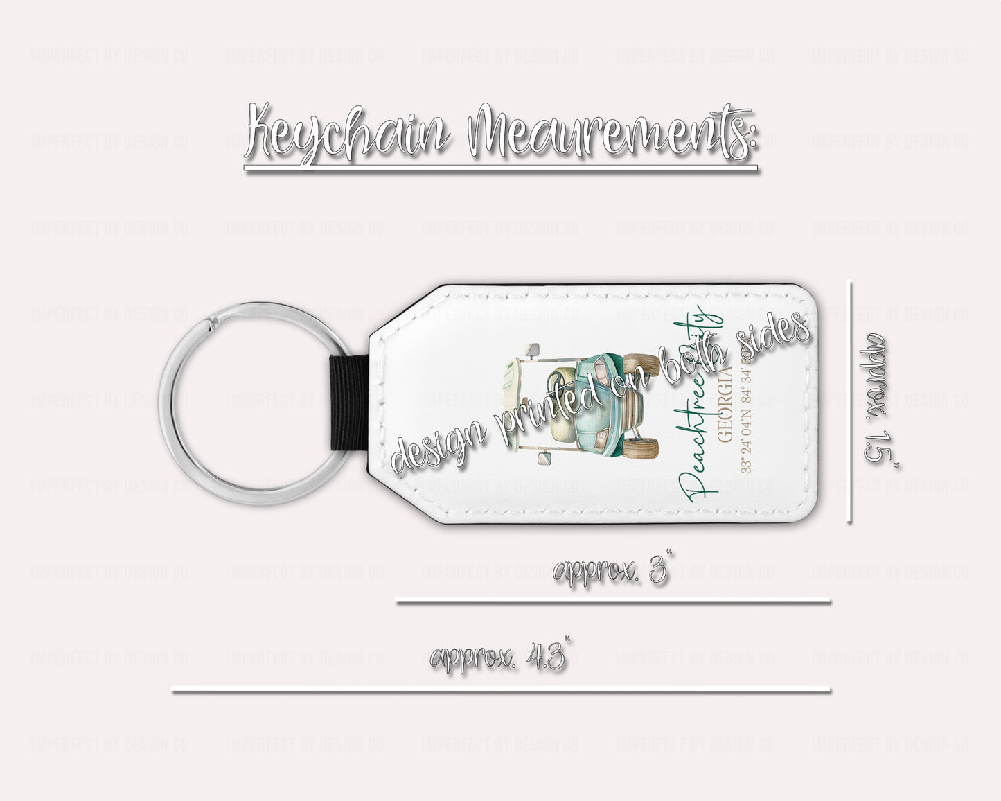 A white faux leather keychain with a blue golf cart and green text, including coordinates, and the text 'Peachtree City, GA'.  This image includes the measurement of the keychain. approximately 1.5 inches wide 3 inches without keyring and 4.3 inches including keyring. On a pale pink background | Exclusive design by imperfect by design co 