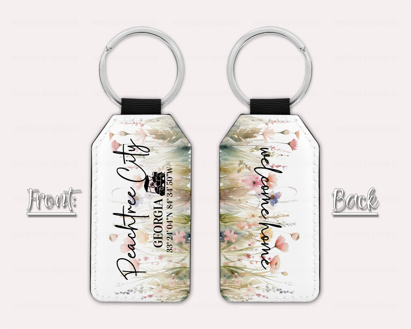 Two Exclusive Peachtree City Wildflower and Poppies Keychain view of front and back, Text on Front features a golf cart and reads "Peachtree City Georgia with Peachtree City coordinates" Back of Key Chain reads "welcome home". Additon text on graphic reads font and back on a pale pink background  | imperfect by design co 