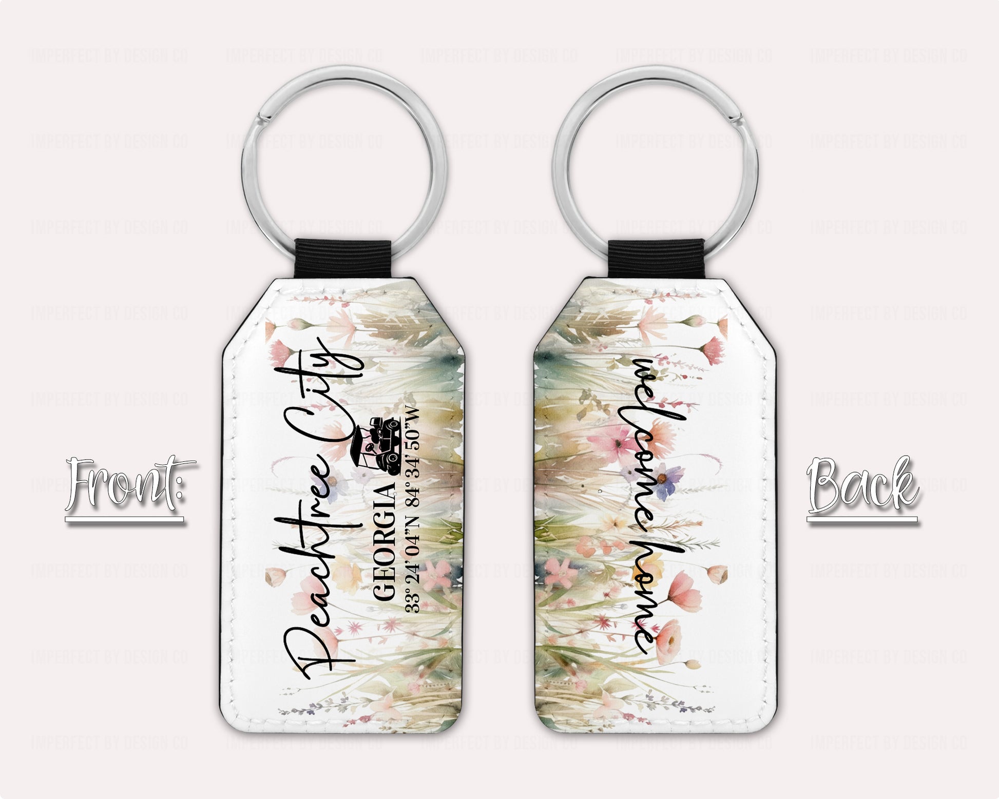 Two Exclusive Peachtree City Wildflower and Poppies Keychain view of front and back, Text on Front features a golf cart and reads "Peachtree City Georgia with Peachtree City coordinates" Back of Key Chain reads "welcome home". Additon text on graphic reads font and back on a pale pink background  | imperfect by design co 