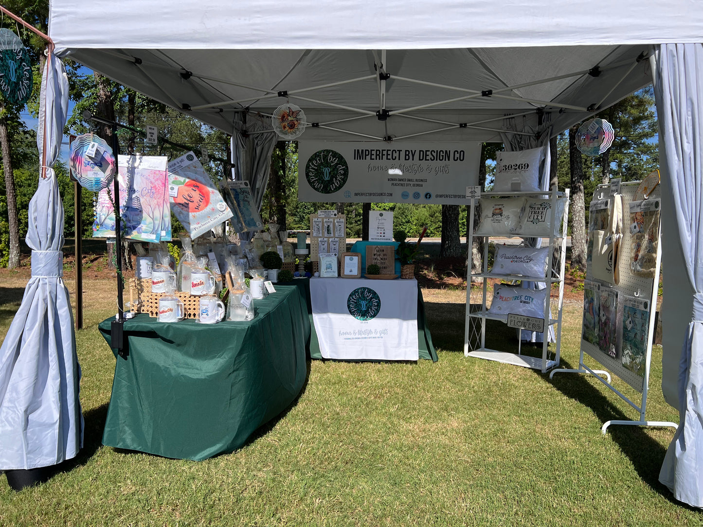 imperfect by design co Outdoor Vendor Market Booth showcasing many ready to gift imperfect by design co exclusive designs