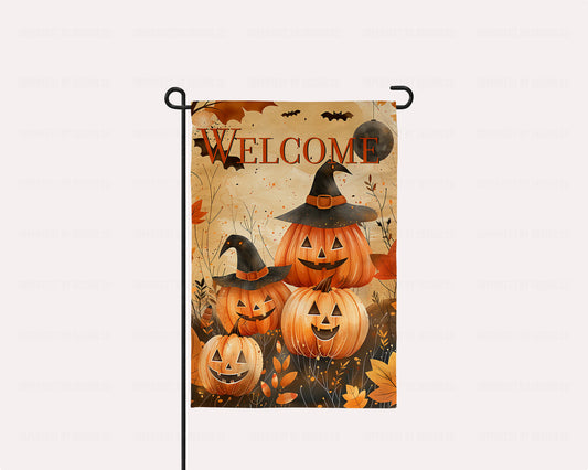 Halloween garden flag with "WELCOME" text and smiling jack-o-lantern family.
