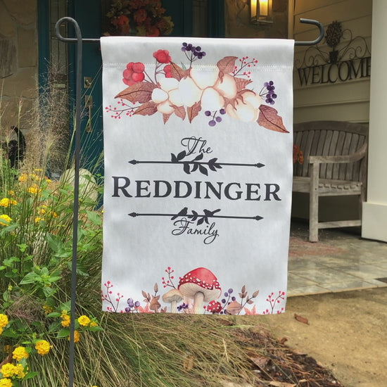 Personalized family name garden flag with autumn mushrooms, berries, and foliage design.