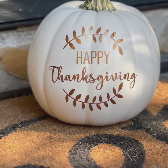 video still of white decorative pumpkin "Happy Thanksgiving" in bronze text