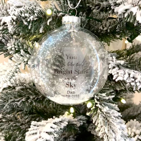 Video still of Ornament displayed on a Christmas tree, featuring custom name and life dates.