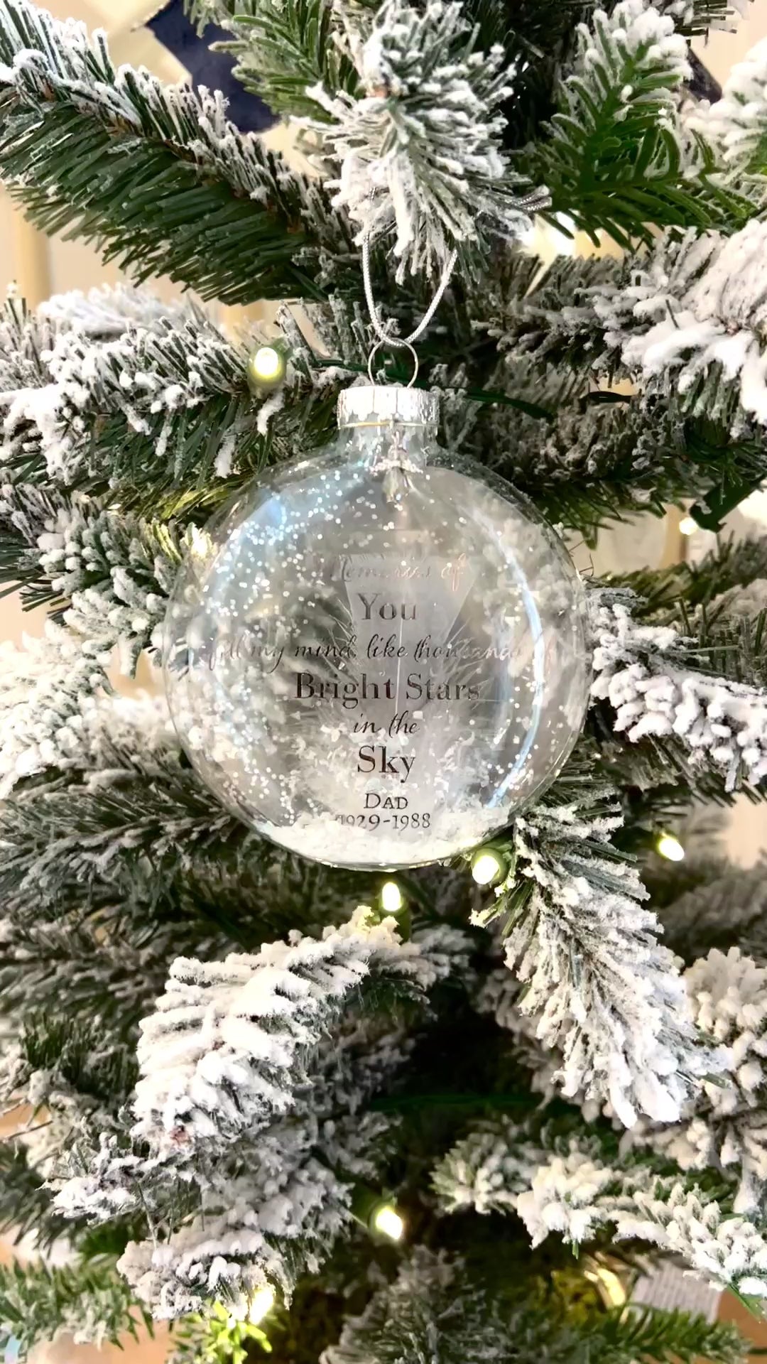 Video still of Ornament displayed on a Christmas tree, featuring custom name and life dates.