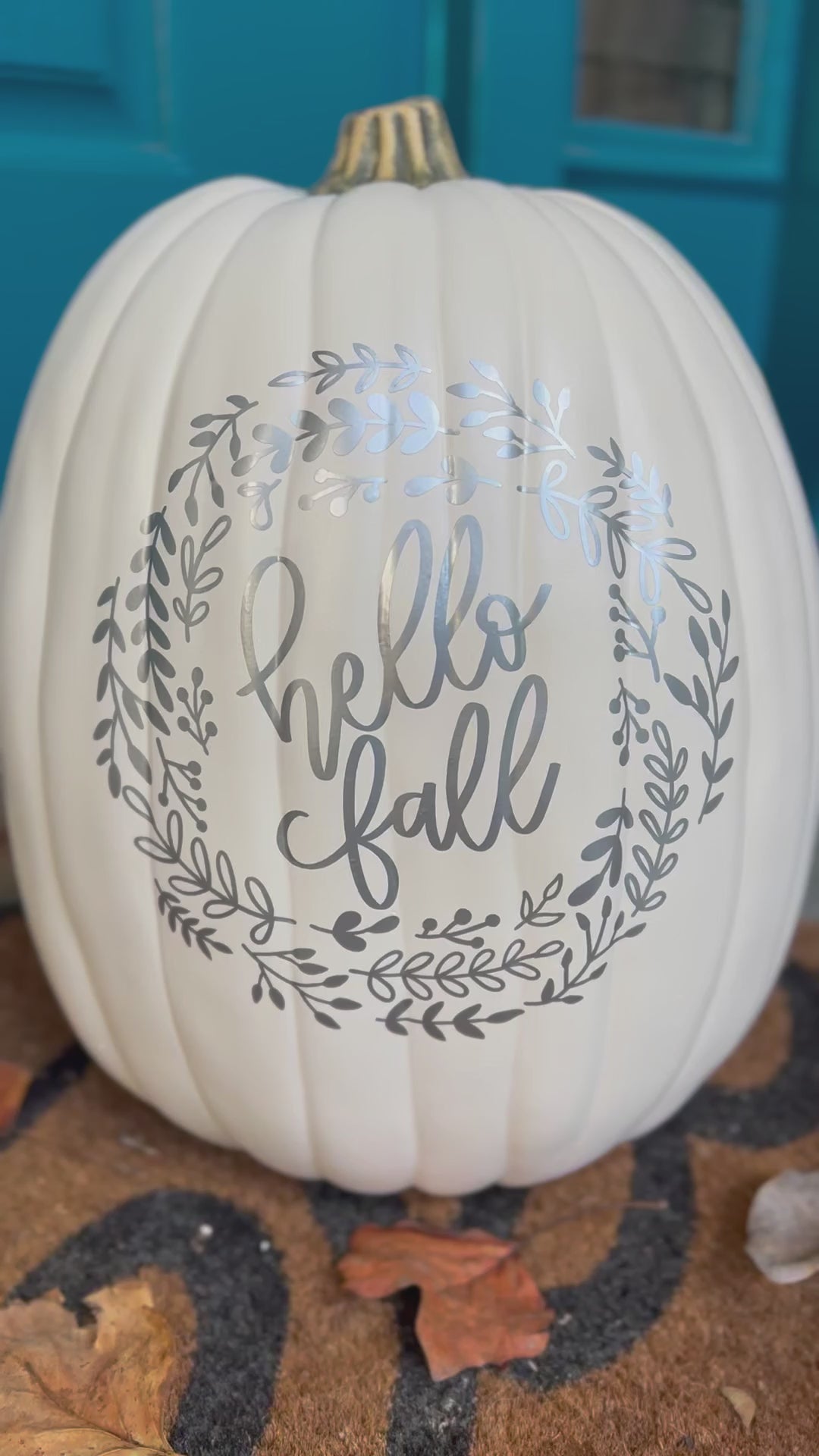 video still of large white decorative pumpkin with silver text "hello Fall